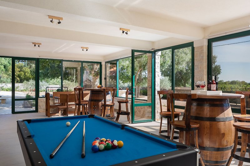 Spacious, glazed terrace with Billiards, Darts, a wooden dining table and two handmade wooden bar tables