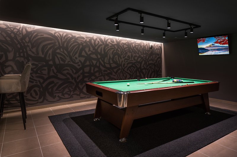 Game room with billiard table and TV
