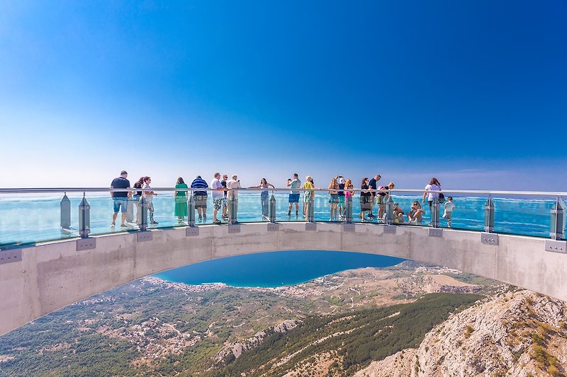A Skywalk Biokovo, a horseshoe-shaped glass walkway just out over a precipitous slope opening out towards the coast