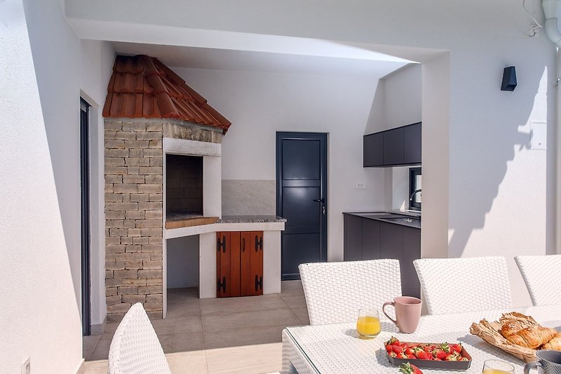 A summer kitchen with a traditional barbecue
