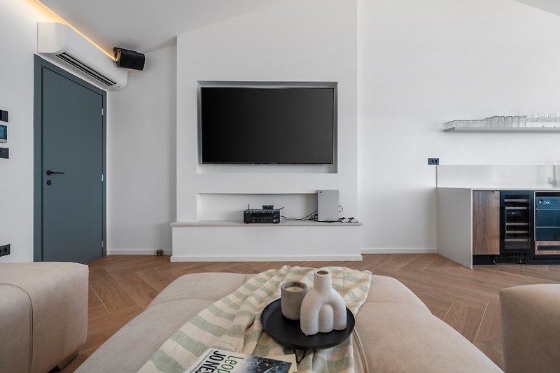 Media room (40sqm) with a huge sofa that can convert into a sofa bed for two, a flat screen TV, a PlayStation5...
