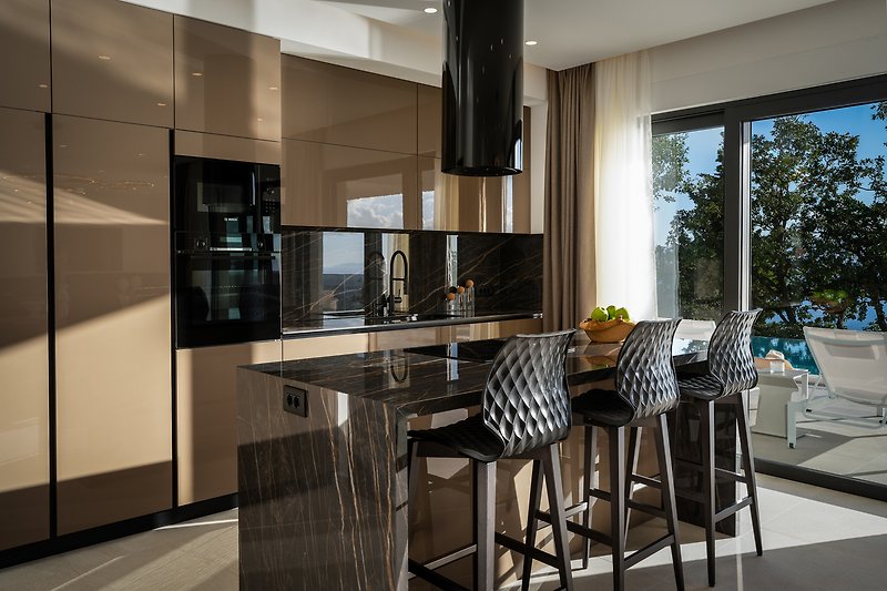 A beautifully designed kitchen with elegant furniture and a view of the outdoors.