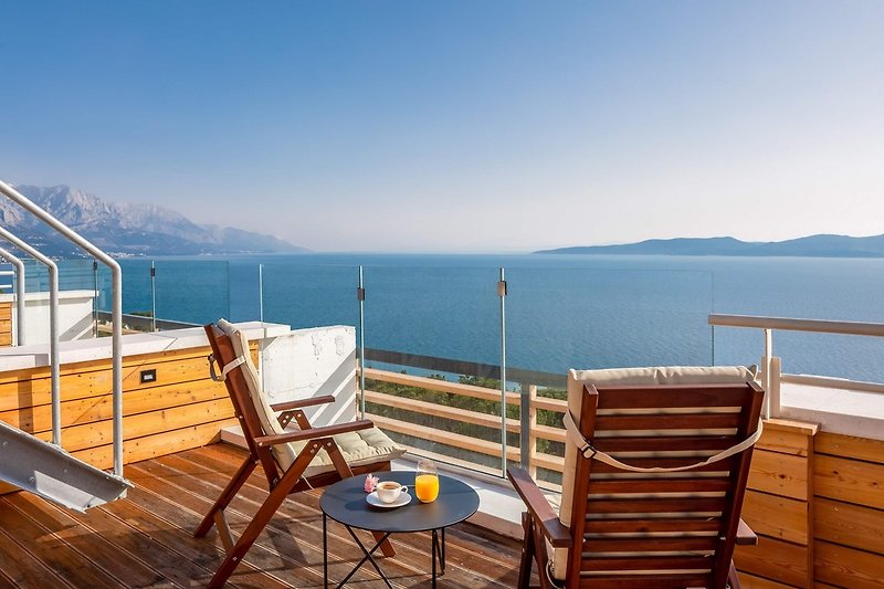 A cozy sitting area with spectacular, elevated views of the Adriatic sea, coast, and islands.