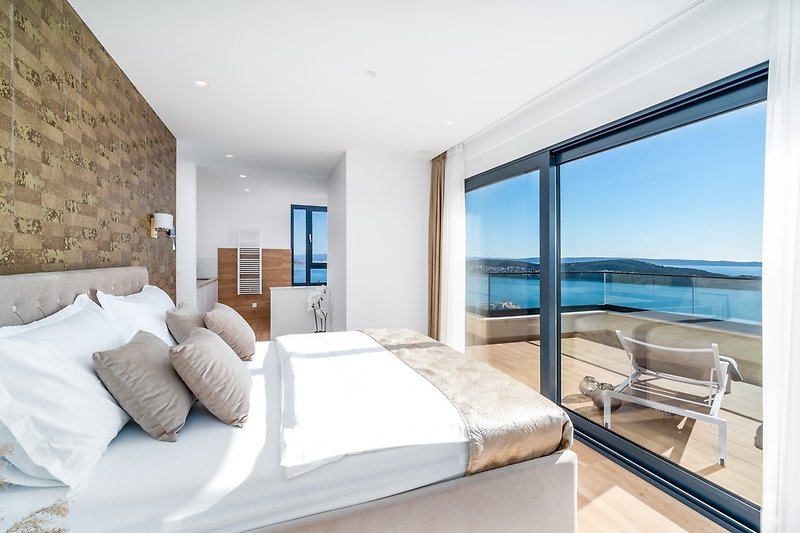 Bedroom No3 (South) with a king-size bed 180cm x 200cm, a TV, Air-conditioning,and sea views.