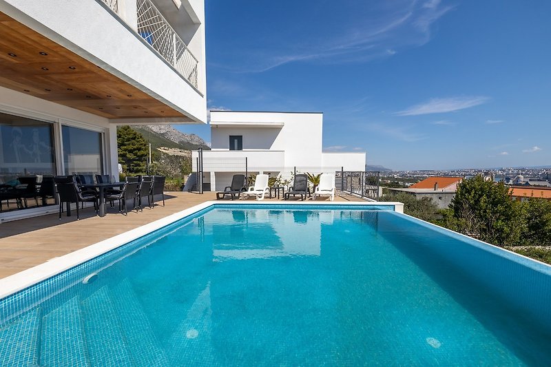Spacious sun-deck area with deck chairs and 36m2 swimming pool