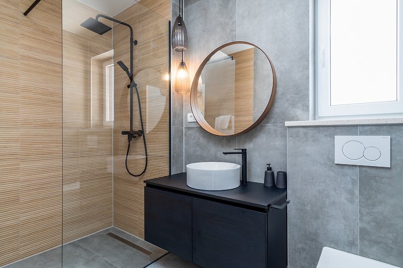 An en-suite bathroom with a shower, a toilet, and a sink