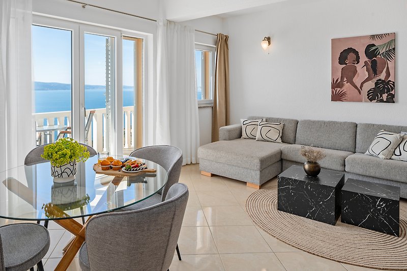 Living area with sofa bed, direct exit to the balcony with amazing sea view