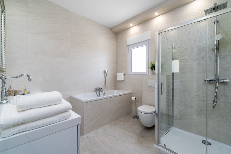 There is a Bathroom (8sqm) next to this bedroom with a bath-tub