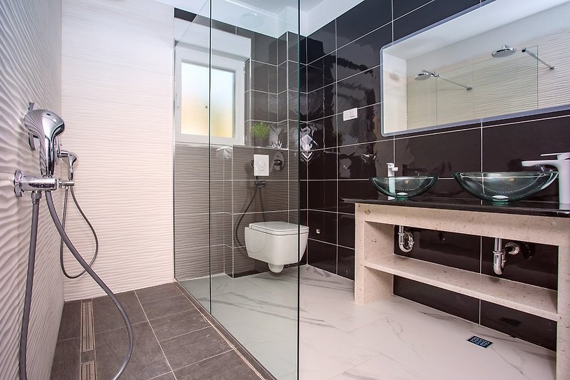 family bathroom with shower and washing machine