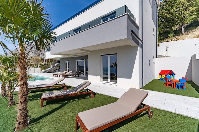 This modern and luxurious villa is situated in a quiet area above small town Omiš