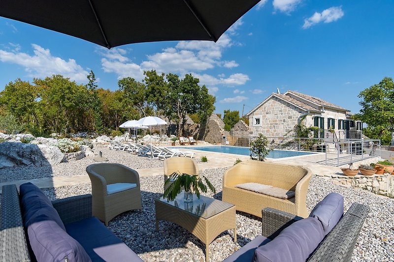 Villa Lugareva is a traditional stone house with a lot of natural light throughout, settled on a land plot of 1.180 sqm.
