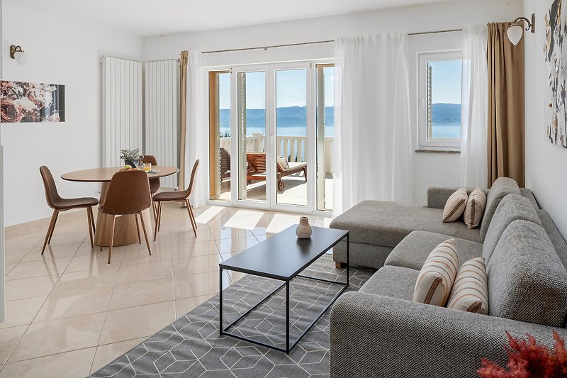 Apartment No.1 on the 1st floor offers a fully equipped kitchen, living and dining area, and an open sea view