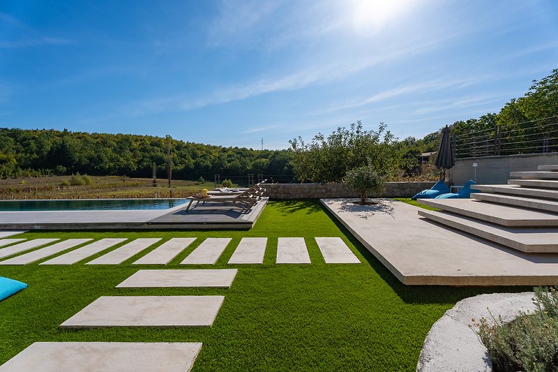 Spacious sunbathing area covered with artificial grass