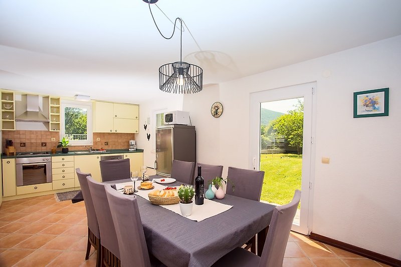 Fully equipped kitchen with exit to playground and outdoor barbecue