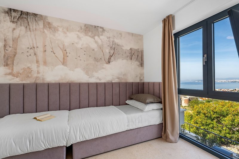 Bedroom NO3  with two single beds 90cm x 200cm, a TV, A/C, en-suite Bathroom with a shower (5sqm), and sea views