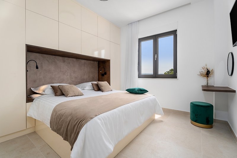 Ein Schlafzimmer Nr. 1 mit einem Kingsize-Bett 180 cm x 200 cm, einem Fernseher, Klimaanlage und Meerblick.
