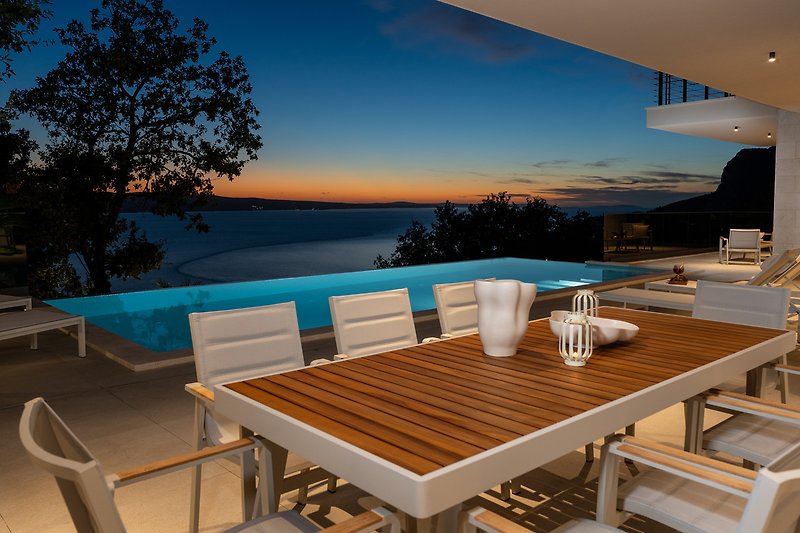 Cozy outdoor dining with comfortable furniture and a beautiful ocean view.