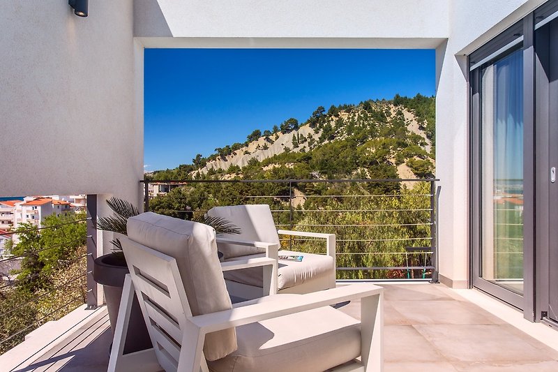 Bedroom No2 also offers a terrace with comfortable outdoor furniture and pool views