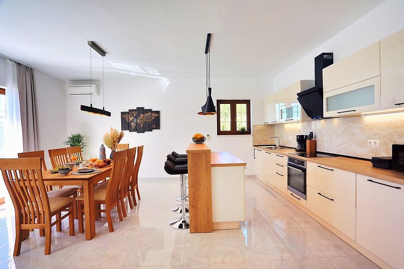 Dining area with a Fully equipped kitchen and direct exit to the pool and outdoor dining area 