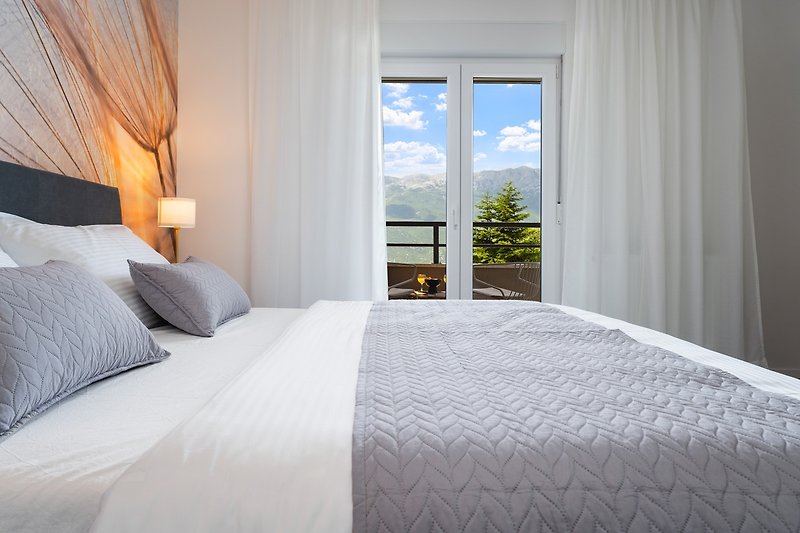 Bedroom No2 is equipped with air-conditioning and a balcony with mountain and pool views