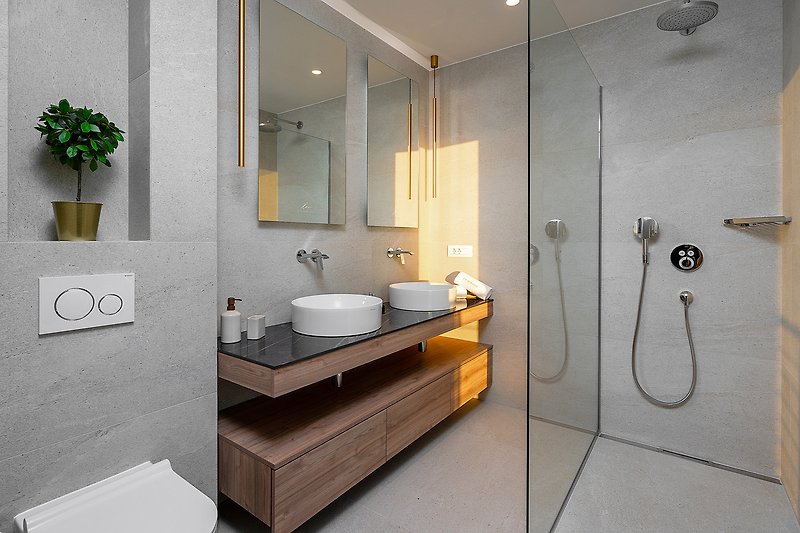 A stylish bathroom with a modern sink, elegant fixtures, and a beautiful mirror.