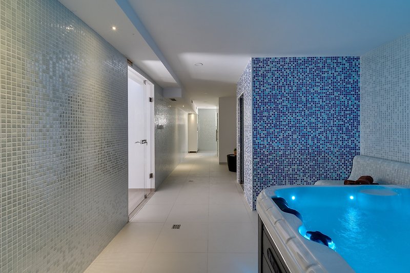 Luxurious spa area with steam room, shower, and whirlpool