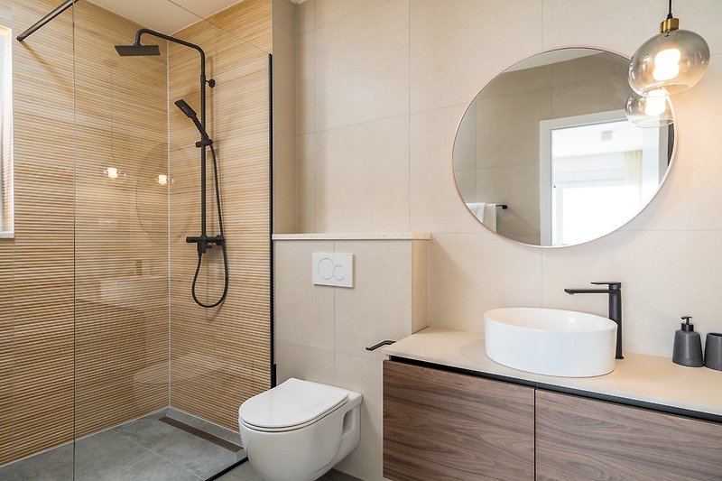 An en-suite bathroom with a shower, a toilet, and a sink