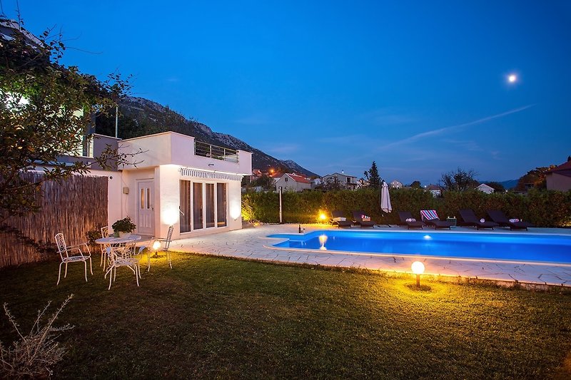 Night view of the villa and outside area.