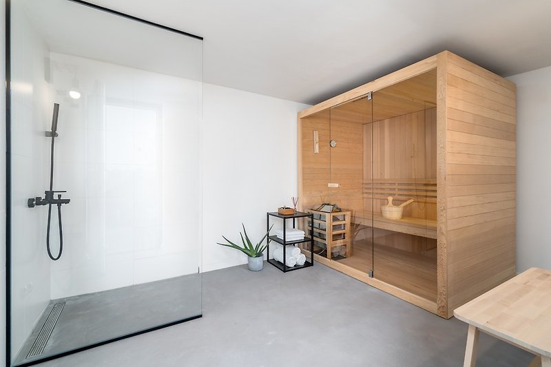Behind the living area, with a few outdoor steps, you are approaching a room with a Finnish sauna and a shower (10,3 sqm).