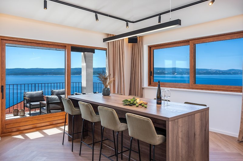 House bar/dining table with a kitchenette (vine cooler, ice maker, dishwasher, espresso coffee maker), opened sea view
