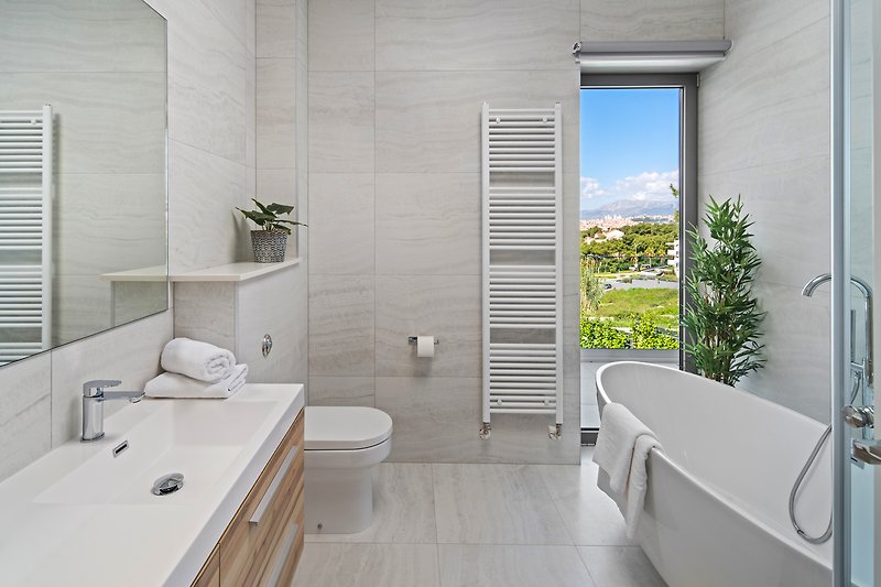 An en suite bathroom with a bathtub and shower