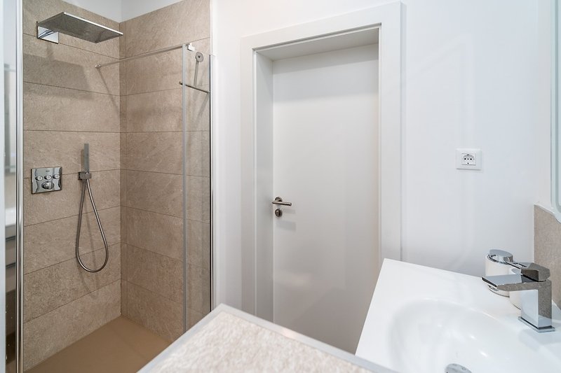 Family bathroom with a shower .