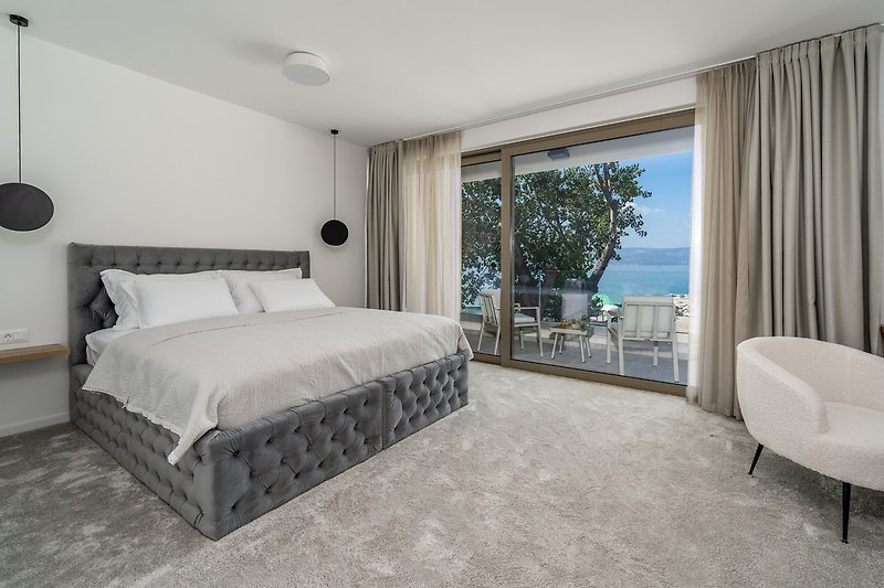 Bedroom No1 (South, 25sqm) offering amazing sea and pool views, with a King size bed 200cm x 200cm, a TV