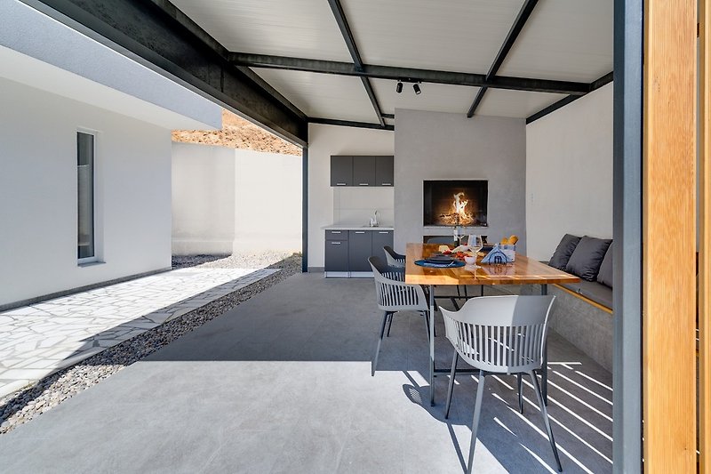 Ein Sonnendeckbereich mit 8 Liegestühlen und Außendusche, eine Sommerküche mit überdachtem Essbereich mit Grill