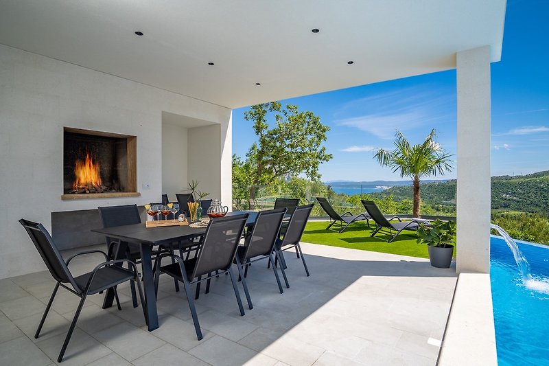 Outdoor dining area with a traditional barbecue