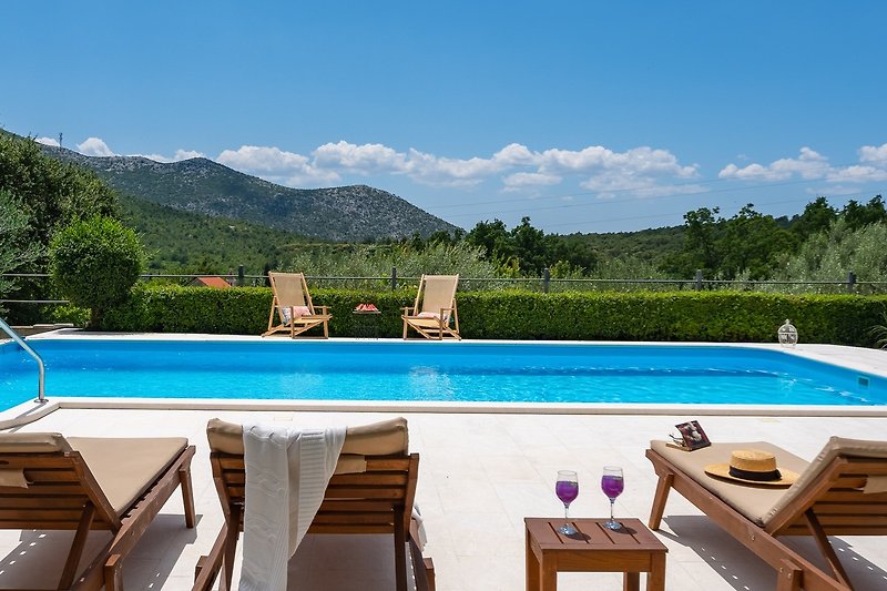 Relax by the poolside with breathtaking views of nature and the azure sky.