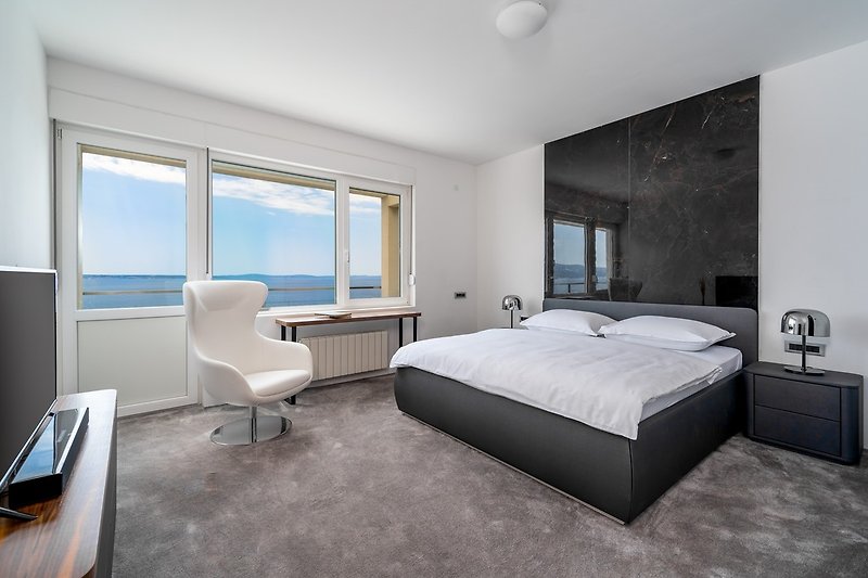 A seaview Bedroom No2 with king size bed 180cm x 200cm, en-suite bathroom with shower, a flat screen TV, air-conditioning