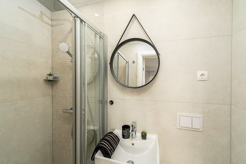 An en-suite bathroom with a shower, a toilet and a sink