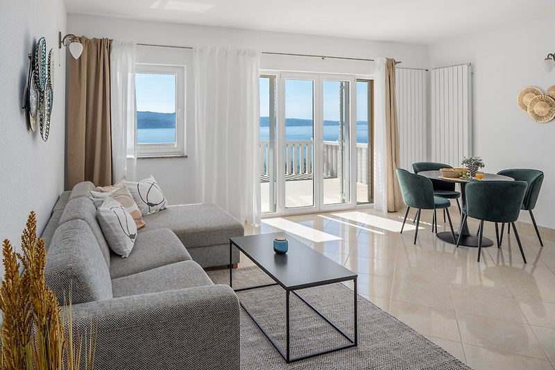 Apartment No.2 on the 1st floor offers a fully equipped kitchen, living and dining area, and an open sea view