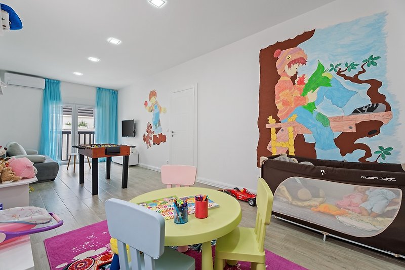 Playroom with a lot of toys, table soccer, play console, sofa bed for two, 1st floor