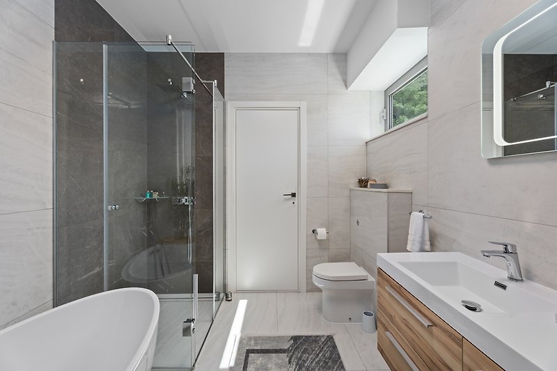 An en suite bathroom with a bathtub and a shower