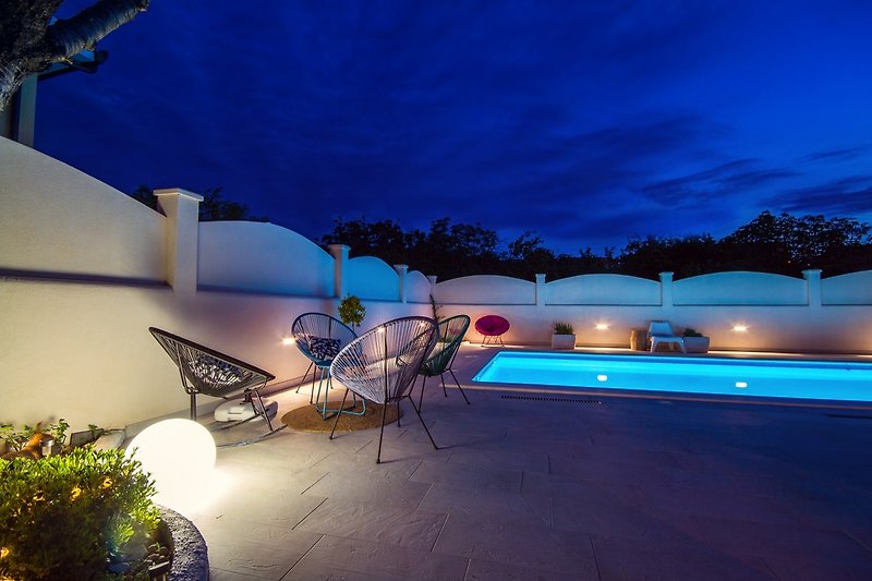 Elegant exterior lighting makes staying alongside the pool very enjoyable