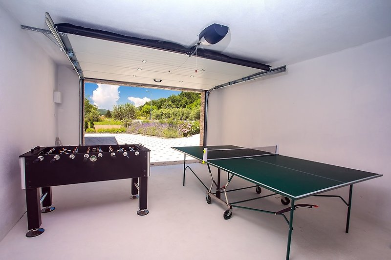 A fun-zone space with table tennis and Foosball
