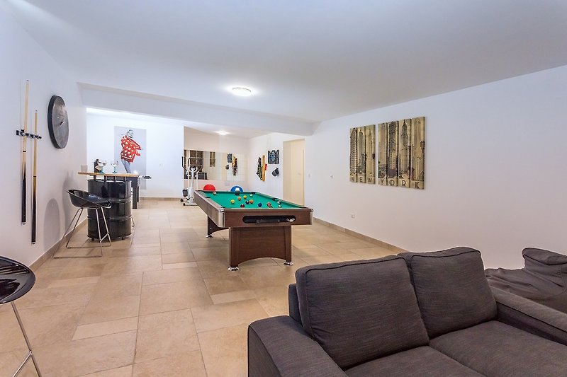 In the fun zone you have a pool table, darts, table soccer, a sofa, PS4 and a TV