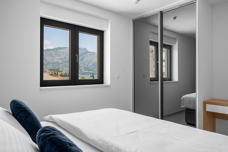 A Bedroom NO2  with a TV, A/C, en-suite bathroom with a shower, partial sea views
