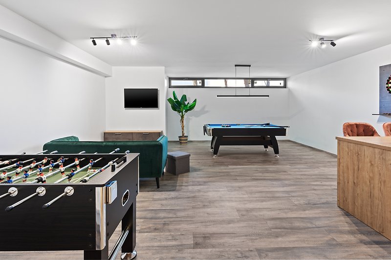 There is a well-organized fun area with a pool table, table soccer, darts