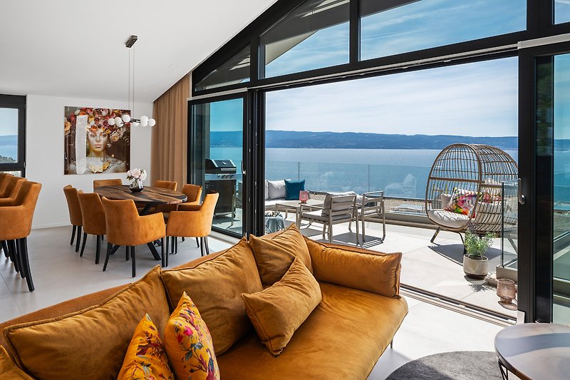 Large windows framing the captivating views of the sparkling sea