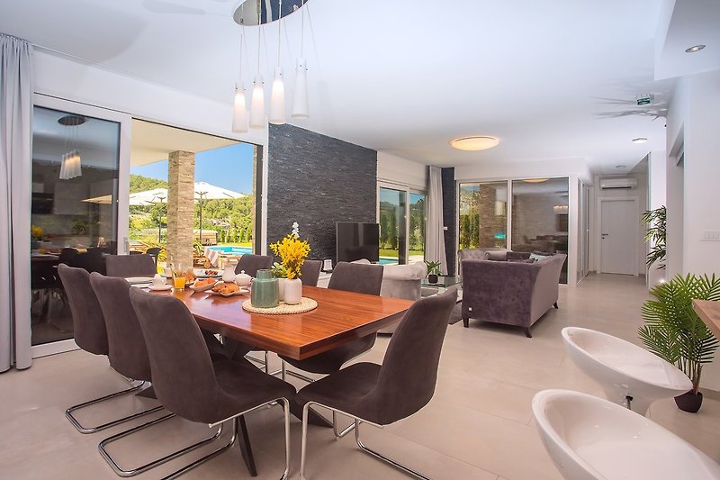 A bright and spacious dining area is connected to an outdoor area
