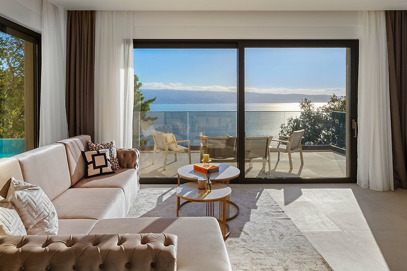 A comfortable living room with stylish furniture and a view of the azure water.