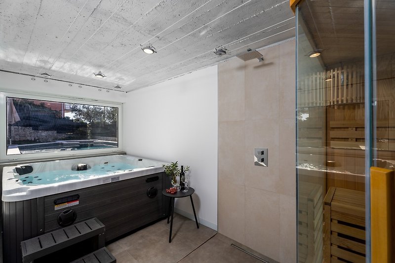 Comfortable Finnish sauna or a Hot-Tub with pool views that are  located in a 16sqm room next to the anteroom.